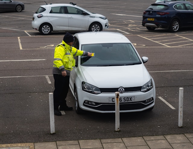 A car getting a parking ticket